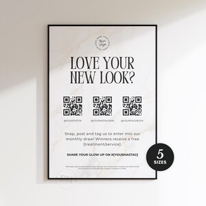 May include: A vertical rectangular sign with a white marble background and black text reading LOVE YOUR NEW LOOK? featuring three QR codes for TikTok, Instagram, and Facebook, instructions for a monthly draw, and a black circle indicating 5 SIZES.