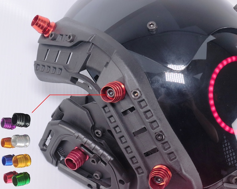 May include: A black helmet with red and silver accents. The helmet has a variety of attachments, including a visor, a chin guard, and a side mount. The helmet is designed for tactical use.