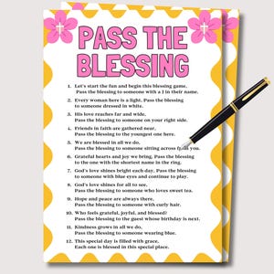 May include: A printed game card titled "PASS THE BLESSING" with a yellow and white border, pink flower accents, and a black pen. The card contains a list of instructions for a blessing game.