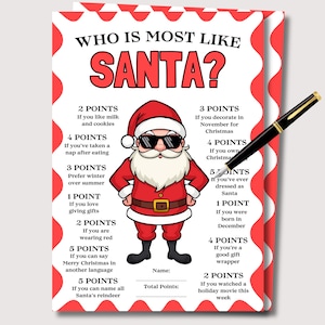May include: A festive Christmas game card titled "Who is Most Like Santa?" features a cartoon Santa Claus with sunglasses. The red and white card includes point-based questions about Christmas traditions, with a black pen resting on the card.