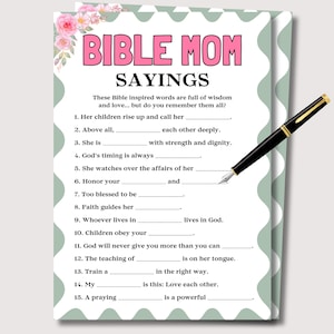 May include: A printable Bible Mom Sayings worksheet with a floral design and the text "BIBLE MOM SAYINGS." A black and gold pen rests on the page, ready for use. The worksheet includes fill-in-the-blank prompts.