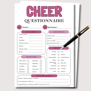 May include: A white paper with a pink and black "CHEER QUESTIONNAIRE" design. The questionnaire includes sections for favorites, food preferences, and "this or that" choices. A black pen with gold accents rests on the paper.