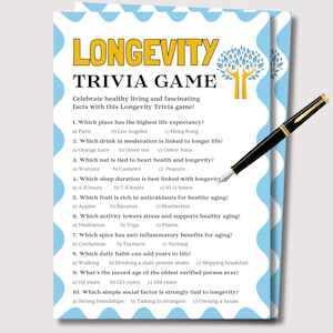 May include: A trivia game card titled "Longevity Trivia Game" with questions about healthy living. The card has a light blue wavy border and a gold and black pen rests on the card. The game includes questions about life expectancy, diet, and habits.