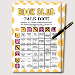 May include: A yellow and white Book Club Talk Dice game card with a black pen. The card features a grid of questions related to reading, with dice icons. The pen is black with gold accents.