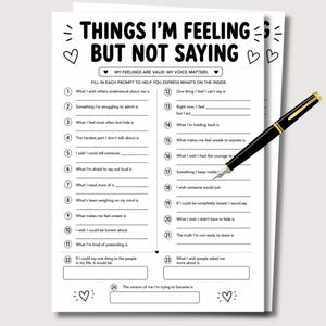 May include: A white paper worksheet titled Things I'm Feeling But Not Saying with twenty-four numbered prompts and blank lines for writing, decorated with small heart icons, accompanied by a black and gold fountain pen resting on the page.