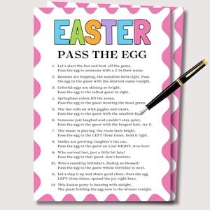 May include: A colorful Easter-themed game card titled "EASTER PASS THE EGG" with pink wavy borders. The card features a list of instructions and is accompanied by a black and gold pen.