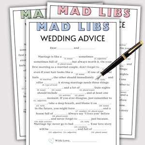 May include: A stack of Mad Libs Wedding Advice sheets with a black pen. The sheets have a white background with black text and fill-in-the-blank prompts. The top sheet has the title "Mad Libs" in pink and green.