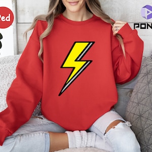 May include: Red sweatshirt with a yellow lightning bolt graphic.
