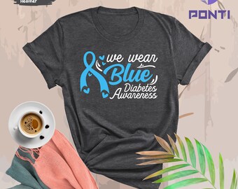 May include: Dark gray heather t-shirt with a blue ribbon and the text "We wear blue, Diabetes Awareness".