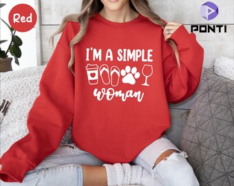 May include: Red sweatshirt with the text "I'm a simple woman" in white. The text is accompanied by a coffee cup, flip flops, a paw print, and a wine glass.