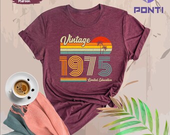 May include: Heather maroon t-shirt with a vintage 1975 graphic and the text "Limited Education". The graphic features a sunset with palm trees.