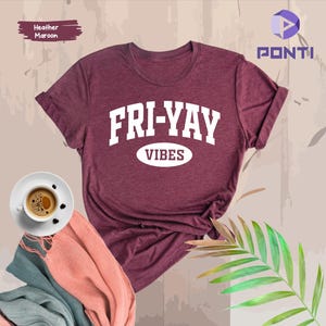 May include: Heather maroon t-shirt with white text that reads "FRI-YAY VIBES".