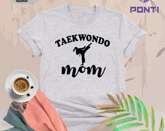 May include: A gray t-shirt with the text "Taekwondo Mom" in black. A silhouette of a person doing a taekwondo kick is above the word "Mom".