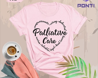 May include: Pink t-shirt with a black circle design that says "Palliative Care" with the words "compassionate, caring, dedicated, warm, reliable, loyal, kind, loving" surrounding the circle.