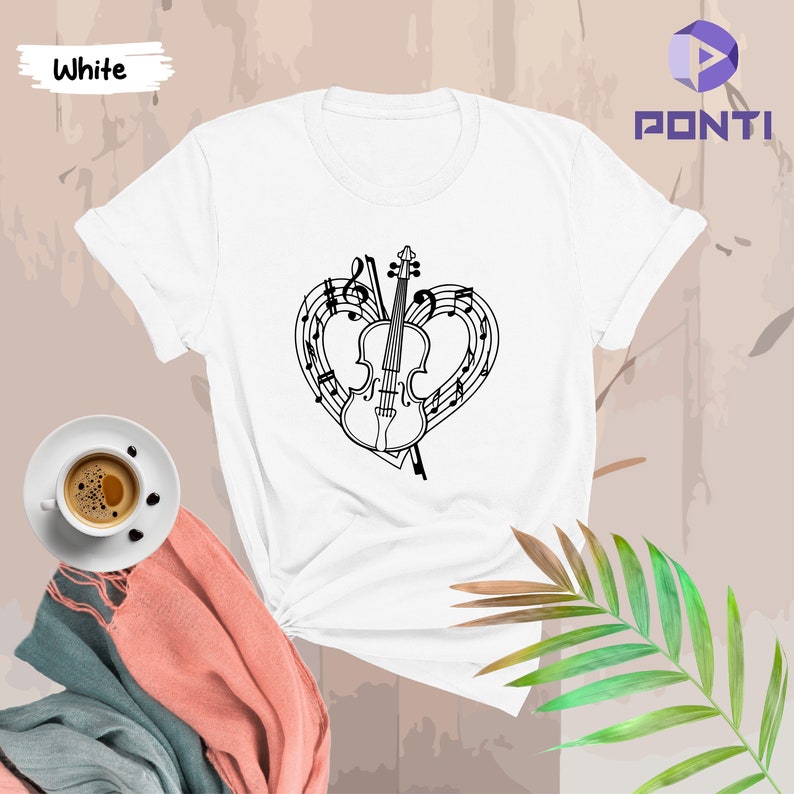 May include: White t-shirt featuring a black and white graphic of a violin within a heart shape formed by musical notes.
