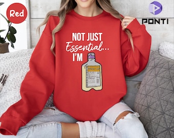 May include: Red sweatshirt with the text "Not Just Essential... I'm" and a graphic of an IV bag.