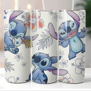May include: Three white stainless steel tumblers with a blue cartoon character, Stitch, from the Disney movie Lilo & Stitch. The tumblers feature different poses of Stitch with a floral and leaf pattern background.