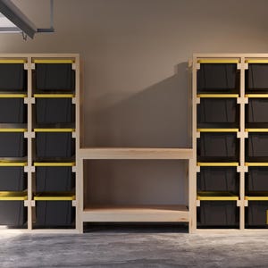 May include: Wooden storage unit with multiple shelves and black bins with yellow rims. The unit includes a central workbench. The design is ideal for garage or workshop organization. The structure is made of light-colored wood.