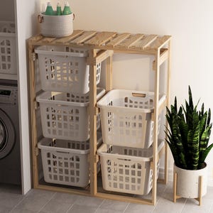 May include: A wooden laundry rack with four white plastic laundry baskets. The rack is made of natural wood and has a rustic look. The baskets are stacked on top of each other and are ideal for storing laundry.