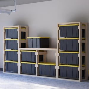 May include: A wooden storage shelf unit with multiple shelves for organizing items. The shelves are filled with black storage bins with yellow lids. The unit is made of natural wood and has a simple design.