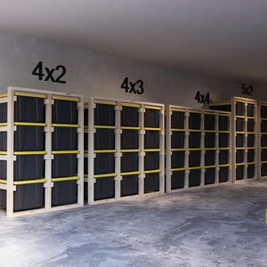 May include: Wooden storage shelving units with black bins and yellow supports. The units are labeled 4x2, 4x3, 4x4, 5x2, and 5x3. The image is taken in a garage or storage space.
