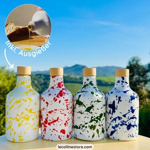 May include: Four ceramic olive oil bottles with cork stoppers and a white background with colourful paint splatters. The bottles are yellow, red, green, and blue.