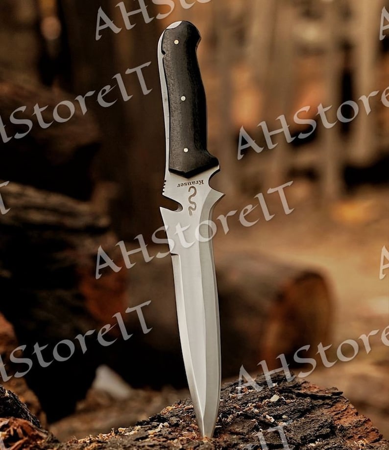 May include: A silver knife with a black wooden handle. The knife has a serrated edge and a pointed tip. The handle has a small metal plate with the word "KRHISSER" engraved on it.