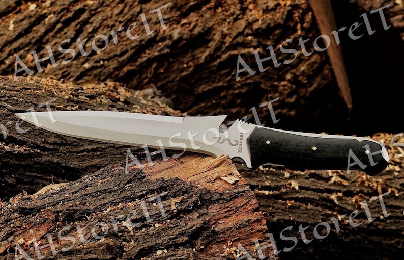 May include: A silver knife with a black handle and a wood grain pattern. The knife has a serrated edge and a pointed tip. The knife is resting on a piece of wood.