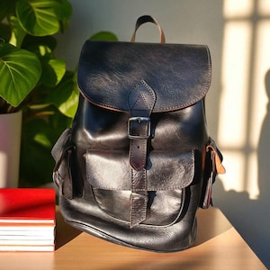 Vintage large black leather backpack from the 1990s, restoration