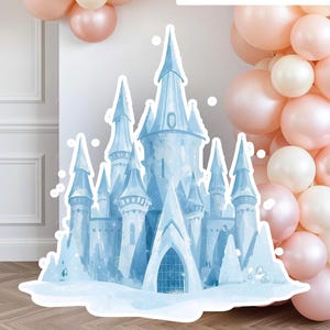 May include: A light blue castle cutout with a watercolor effect, featuring multiple turrets and a snowy base. The text "2 versions included" is visible. The castle is set against a backdrop of pink and white balloons, creating a festive atmosphere.