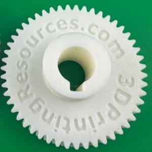 May include: A white 3D-printed gear with a central hole and teeth around the perimeter. The text "3D printing resources.com" is etched into the gear's surface. The gear is set against a green background.