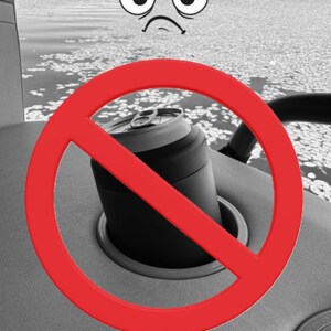 Puede incluir: Una lata negra y plateada en un portavasos, con un letrero de prohibici&oacute;n rojo encima. El fondo muestra un lago con nen&uacute;fares y una cara de dibujos animados con expresi&oacute;n de enfado.