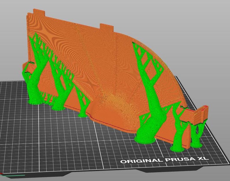 May include: A 3D-printed model featuring a large, curved orange structure with a textured surface, supported by several bright green tree-like structures. The model sits on a black grid, with "ORIGINAL PRUSA XL" text.