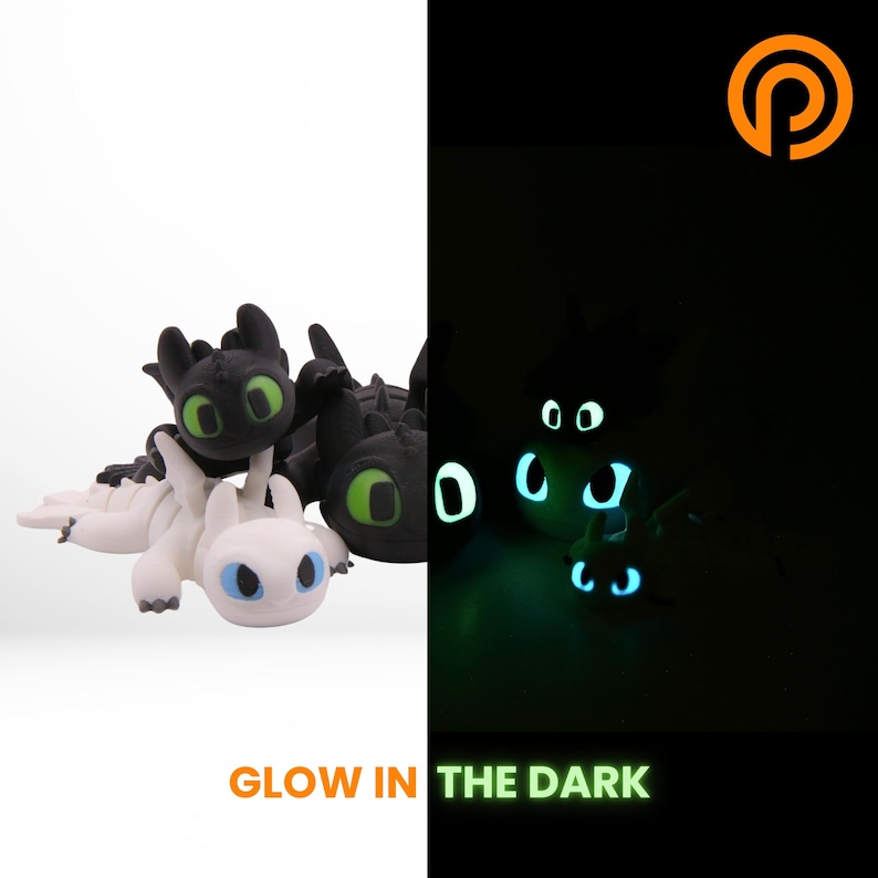 The same dragon photographed in a darkened room, its eyes and accent markings glowing pale green-blue. The body outline is faintly visible, showing where the glow pigment sits.
