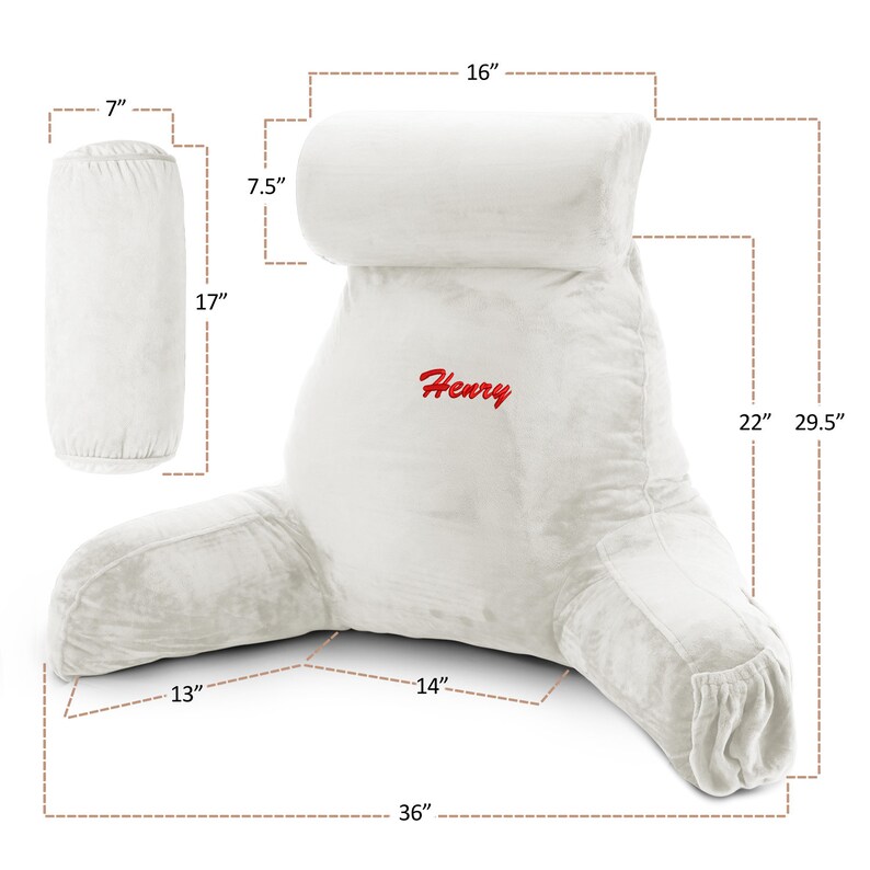 May include: White plush reading pillow with armrests and a headrest. The pillow is 91 cm wide, 75 cm tall, and 56 cm deep. The headrest is 41 cm wide and 19 cm tall. The pillow has the name "Henry" embroidered on it.