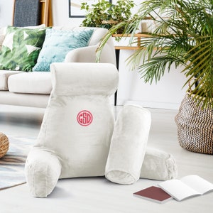 May include: White plush reading pillow with armrests and two smaller pillows. The large pillow has a pink monogram "GSD" embroidered on the front.