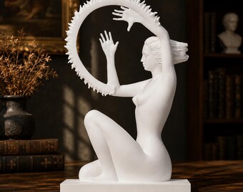 May include: A matte white sculpture of a seated figure with long hair, positioned in profile. The figure holds a large, circular ring with a jagged, sun-like outer edge. The entire piece is mounted on a rectangular white base.