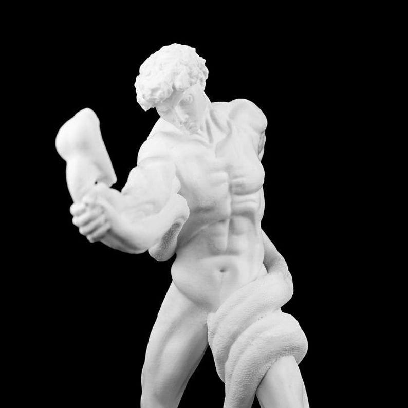 May include: A white sculpture of a muscular male figure, possibly a classical statue, with a snake wrapped around his body. The figure is holding a broken arm. The background is black.