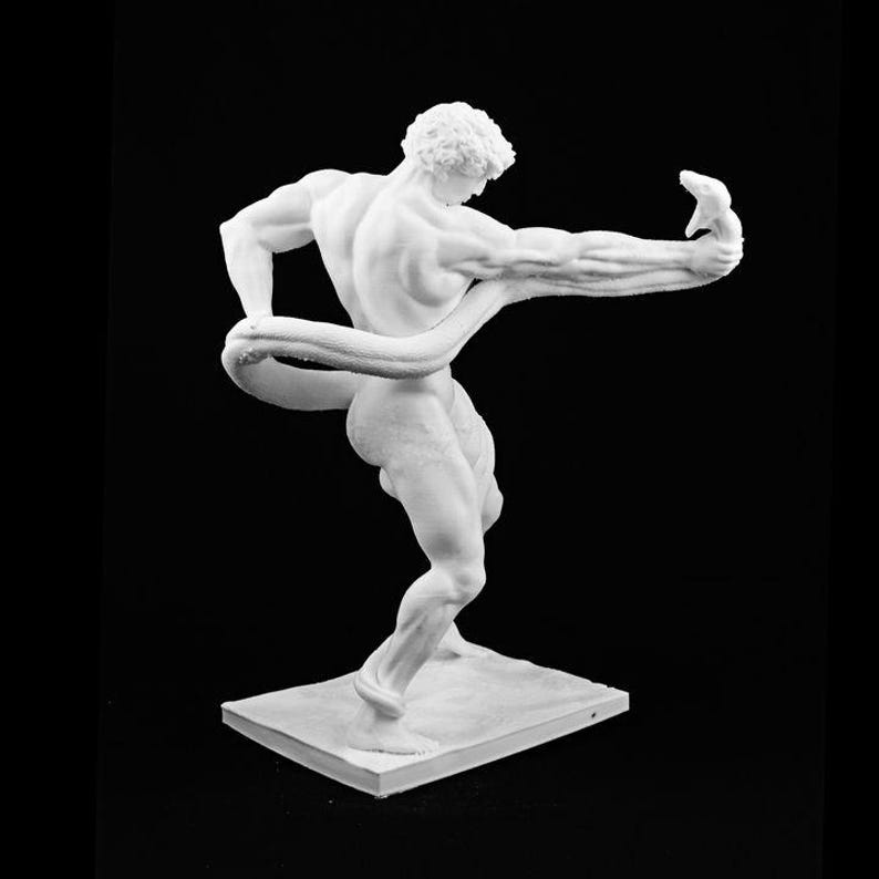 May include: A white sculpture of a muscular figure in a dynamic pose, holding a snake. The figure is on a rectangular base against a black background. The sculpture's details are finely rendered, showcasing the anatomy and movement.
