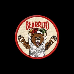 May include: A circular embroidered patch with a cream-colored background and a red border. It features a brown bear wrapped in a white tortilla, resembling a burrito, with the red text "BEARRITO" arched above the bear's head.