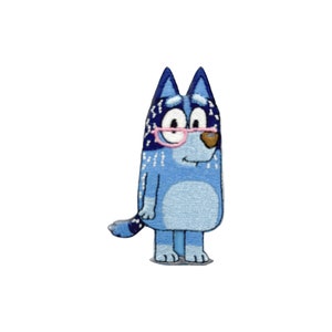 May include: Embroidered patch featuring a cartoon dog character in shades of blue. The dog wears pink glasses and has a light blue body with darker blue accents. The patch is designed to be ironed or sewn onto fabric.