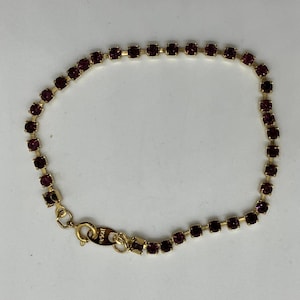 Vintage Avon Gold Tone Tennis Bracelet with Purple Rhinestones