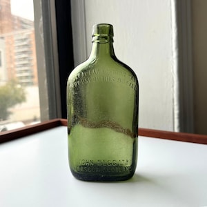Green John Begg Whiskey Bottle – 1930s Embossed Glass – Vintage Bar Decor – Fall Apothecary Style