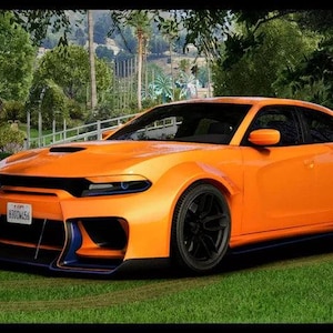 May include: Bright orange sports car with black wheels and a rear spoiler, parked on green grass. The car has a custom front bumper with blue accents and a license plate. The background features trees and a glimpse of a building.