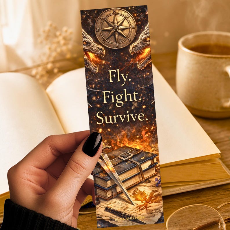 May include: A fantasy bookmark with a compass, dragons, and the text "Fly. Fight. Survive." The bookmark has a detailed illustration of books, swords, and a phoenix. The colour palette includes gold, brown, and orange.