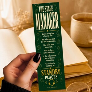 May include: A rectangular dark green bookmark featuring the text THE STAGE MANAGER in large white letters, followed by descriptive text about the role, and the words STANDBY PLACES at the bottom, accented with small gold icons of headsets and clocks.
