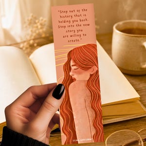 May include: Bookmark with an illustration of a woman with long red hair and the text "Step out of the history that is holding you back. Step into the new story you are willing to create." The bookmark is peach-colored.