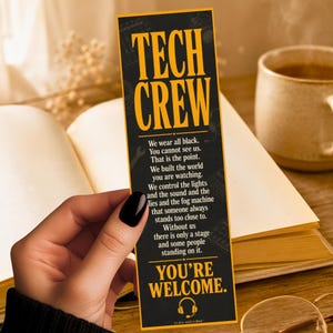 May include: A rectangular black bookmark with a yellow border and yellow text that reads TECH CREW. The text continues with a paragraph about stage work and concludes with YOU'RE WELCOME and a small yellow headphone icon at the bottom.