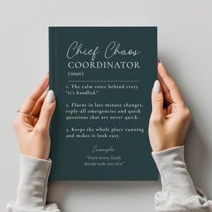May include: A dark teal notebook with white text that reads Chief Chaos Coordinator (noun), 1. The calm voice behind every it's handled. 2. Fluent in last-minute changes, reply-all emergencies and quick questions. 3. Keeps the whole place running.