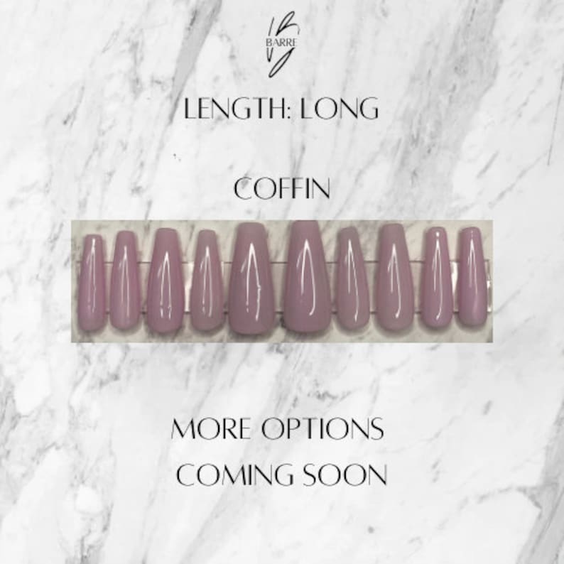 May include: A set of long, coffin-shaped false nails in a muted mauve color. The nails are arranged in a row, showcasing their shape and length. The image includes text that reads "Length: Long", "Coffin", "More Options Coming Soon".